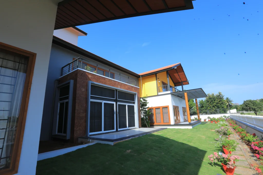 Modern luxury exterior design with contemporary elevation, stone cladding, and architectural lighting in Vellore.