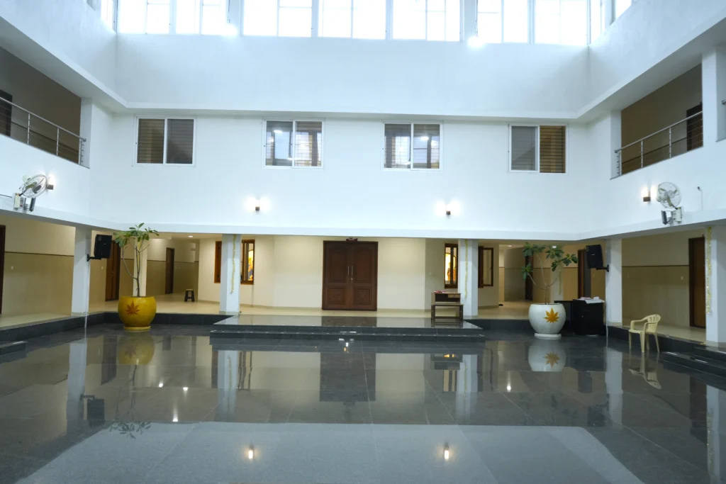 Modern hotel lobby interior featuring a spacious atrium, polished granite flooring, contemporary lighting, elegant entrance, and premium commercial interior design in Tamil Nadu.