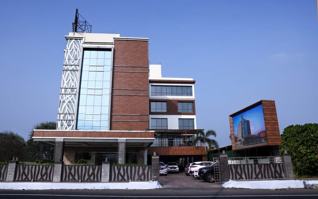 Modern hotel exterior design featuring brick cladding, glass facade, contemporary architecture, and premium commercial building design in Tamil Nadu.