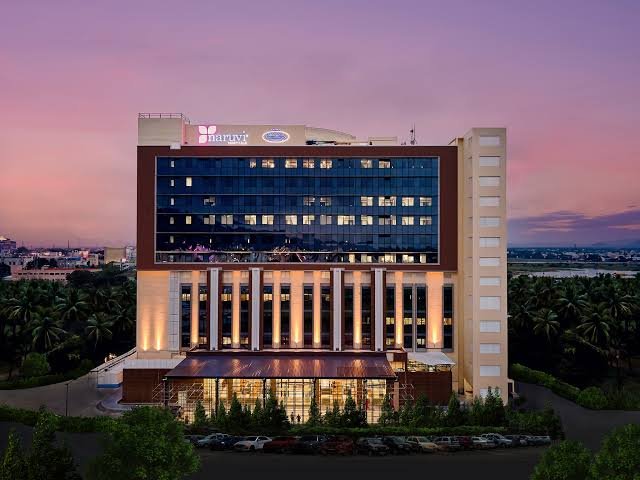 Modern hospital interior and exterior design featuring healthcare architecture, patient-friendly interiors, contemporary facade, landscape design, and medical facility planning in Tamil Nadu.
